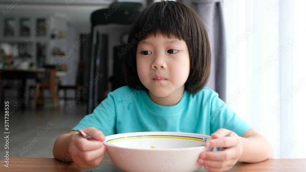 Asian kid eating noodles with blur background
Asian kid eating noodles with blur background