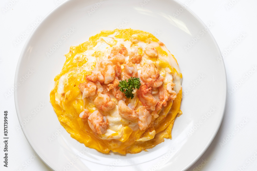 Creamy omelette with shrimps on rice isolated on white background. Delicious and easy menu.  