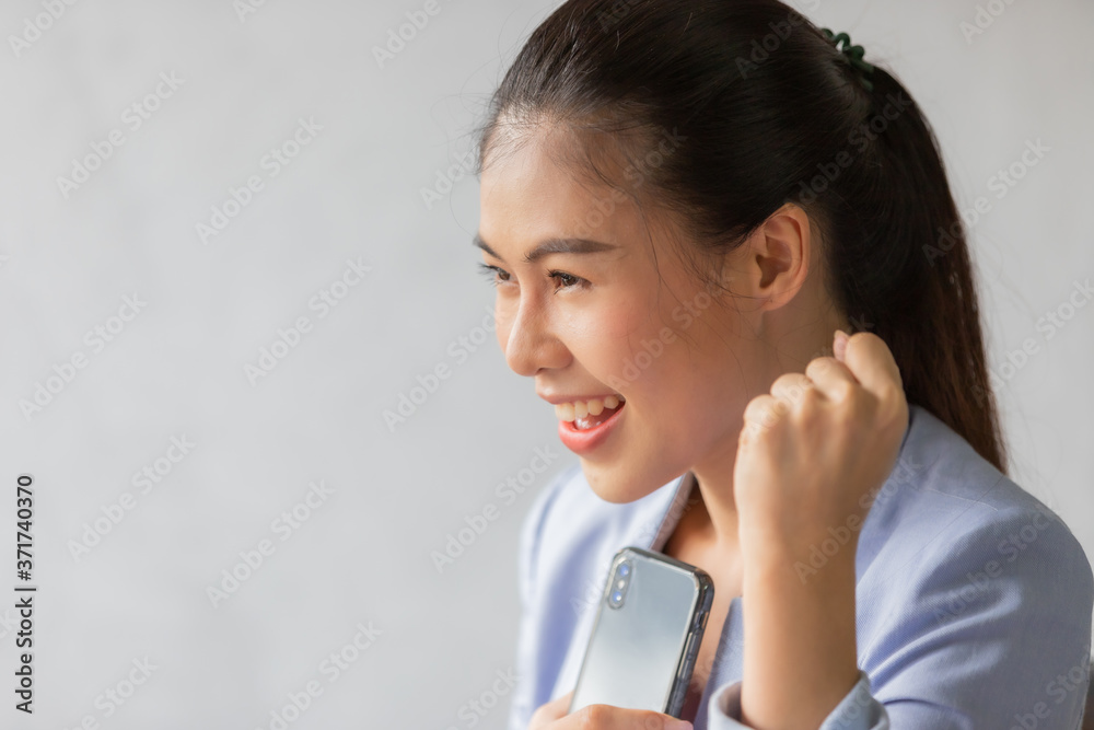 Business woman feeling success after looking on mobile phone Business woman feeling success after looking on mobile phone