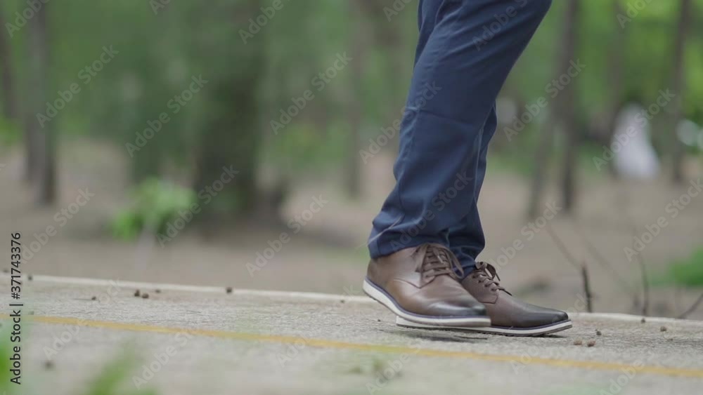 Close up man feet walking