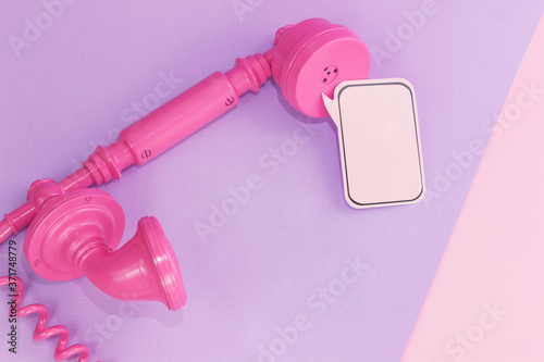 Pink telephone receiver on a colorful background. Place for your text. Comic book concept. Minimalism. Support © Alisa