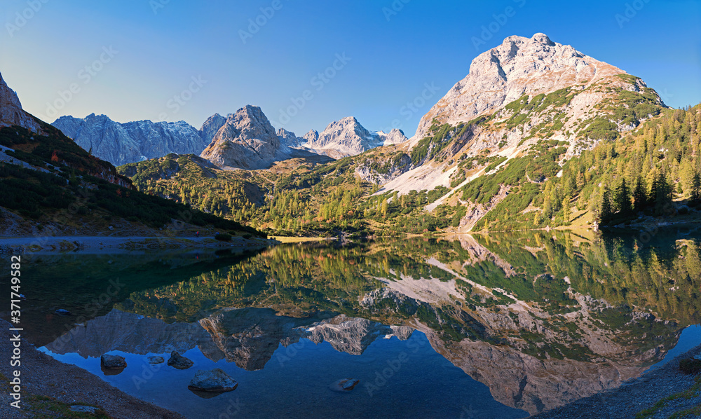 idyllic mountain lake Seebensee in the morning with perfect water reflection