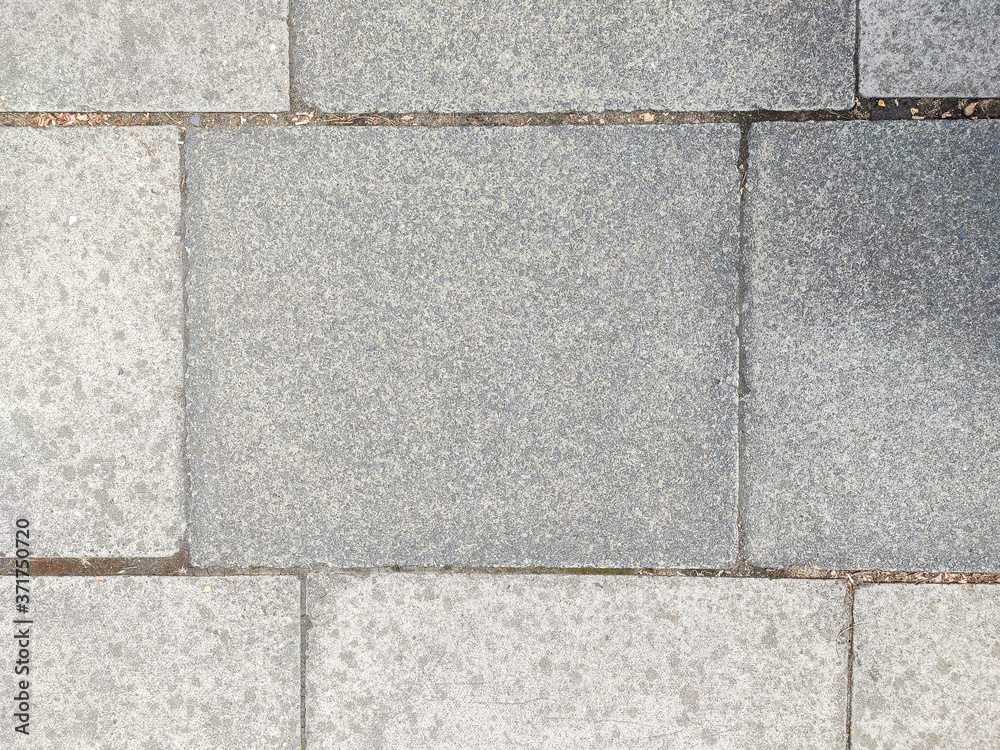 Obraz premium UK pavement grey paving stones in the street