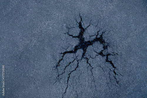 Fotografie Cracked asphalt road background texture. Top view.