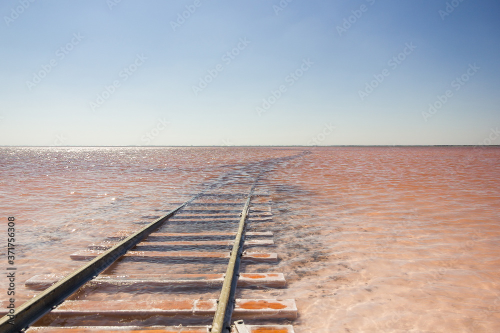 Close-up of the railway on the beach of the salty pink lake Bursol (Altai Territory).