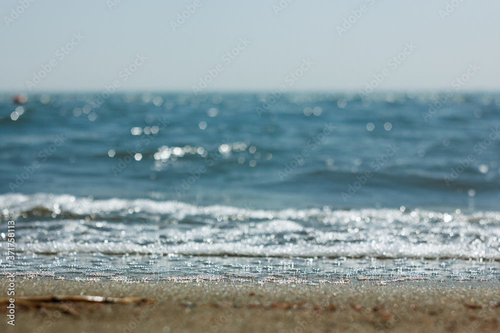 Close-up of sand on the beach and water of the Yarovoe salt lake (Altai Territory).