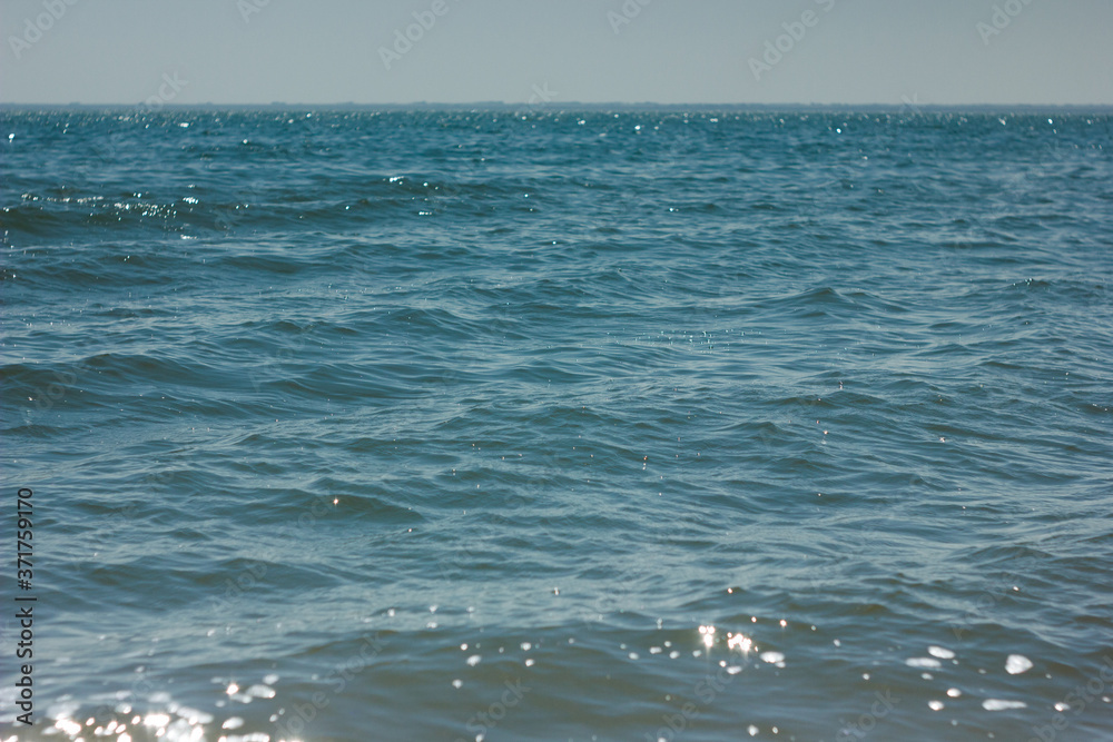 Close-up of sand on the beach and water of the Yarovoe salt lake (Altai Territory). Close-up of sand on the beach and water of the Yarovoe salt lake (Altai Territory).
