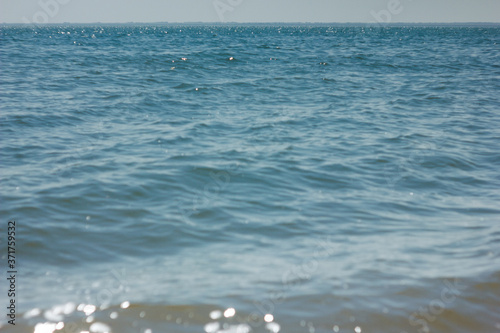 Close-up of sand on the beach and water of the Yarovoe salt lake (Altai Territory).