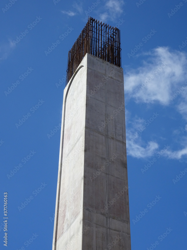 SEREMBAN, MALAYSIA -MARCH 7, 2020: Steel reinforced concrete column under construction. Reinforcement bar on top of column ready for the next stage of construction. SEREMBAN, MALAYSIA -MARCH 7, 2020: Steel reinforced concrete column under construction. Reinforcement bar on top of column ready for the next stage of construction.