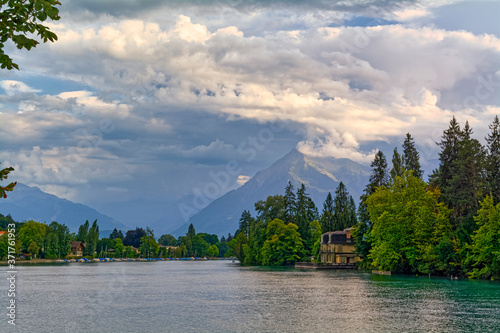 Beautiful view of Thuner lake, Canton of Bern, Switzerland, with cloudy sky in late afternoon.