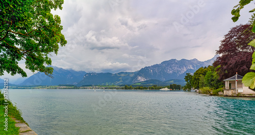 Beautiful panoramic view of Thuner lake, Canton of Bern, Switzerland, with cloudy sky in late afternoon.