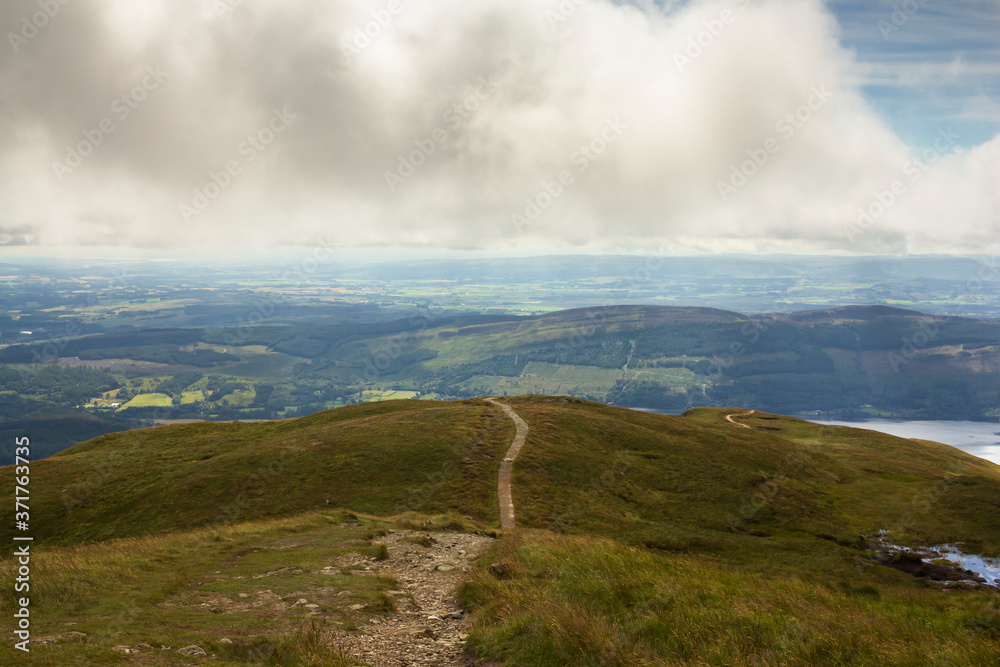 Views of Stirlingshire in Scotland on a lovely summersday from the top of the mountain Ben Ledi
Views of Stirlingshire in Scotland on a lovely summersday from the top of the mountain Ben Ledi
