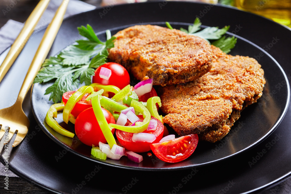 close-up of breaded lamb chops and salad close-up of breaded lamb chops and salad