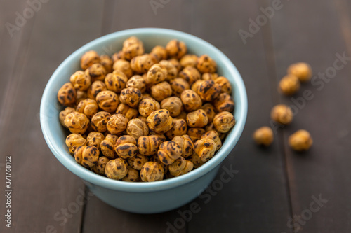 Roasted Chickpea in a bowl on wooden background. Turkish known as leblebi