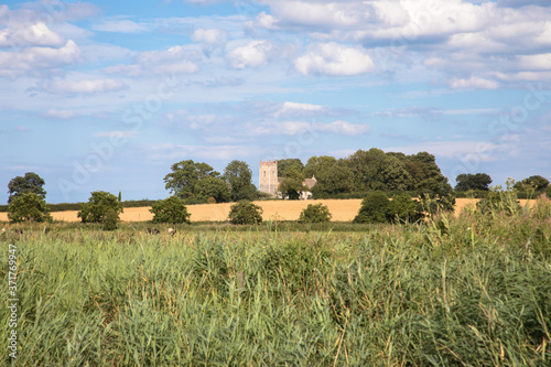 View of Saint Edmund Church in Thurne from the River Bure, The Broads, Norfolk, UK photo