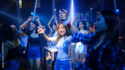asian young woman crowd of people dancing in night club