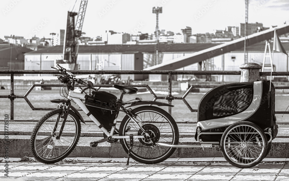 Isolated Child Bicycle Trailer parked in a pier Isolated Child Bicycle Trailer parked in a pier