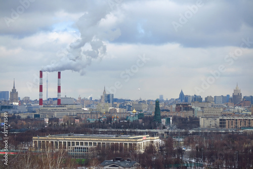 Smoke coming out of the chimneys of a thermal industrial station during winter in Moscow, Russia.