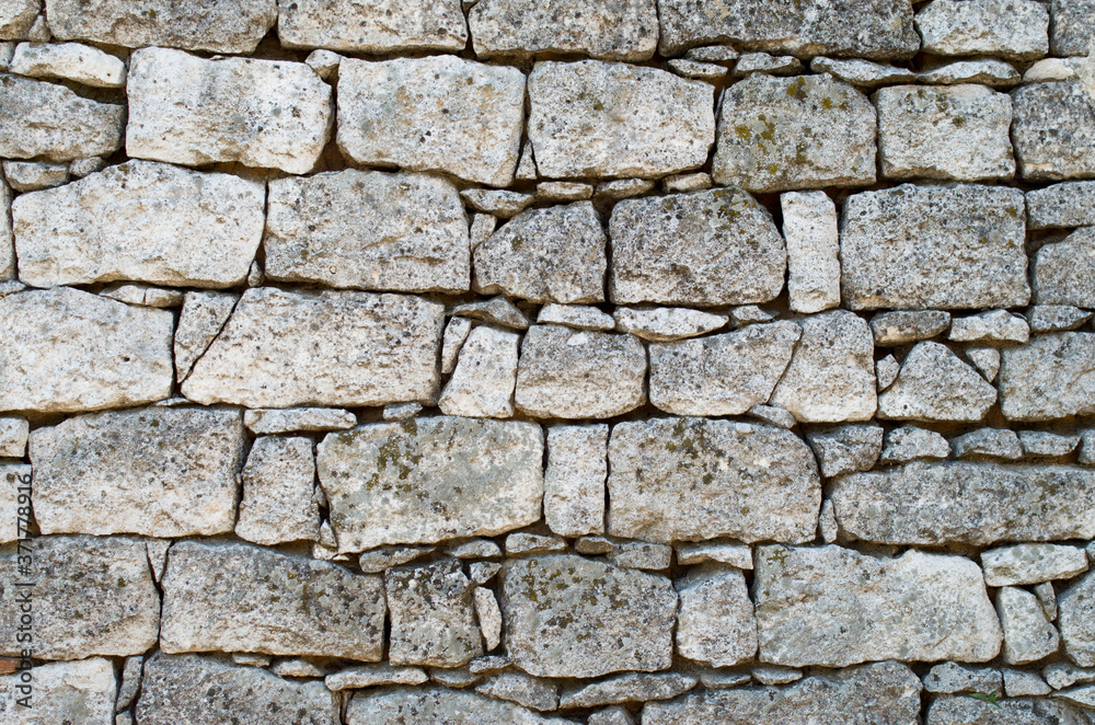 Fototapeta premium Old white stone wall closeup