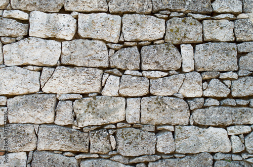 Old white stone wall closeup