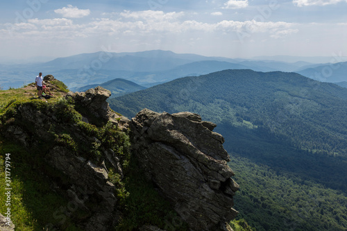 Summer landscape of the Carpathians on a sunny day. The main watershed. Mount Pikuy, Ukraine. Rock ledges on a background of mountains. Landscape with high mountains. © ihorhvozdetskiy