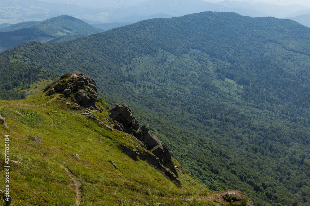 Summer landscape of the Carpathians on a sunny day. The main watershed. Mount Pikuy, Ukraine. Rock ledges on a background of mountains. Landscape with high mountains. Summer landscape of the Carpathians on a sunny day. The main watershed. Mount Pikuy, Ukraine. Rock ledges on a background of mountains. Landscape with high mountains.