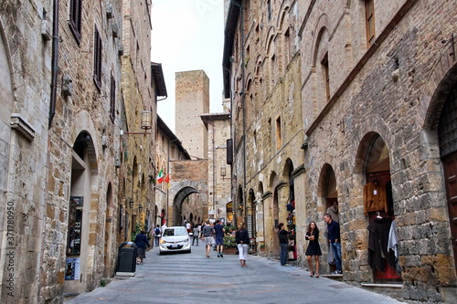 Unidentified people on the street of San Gimignano  Italy. Historic Centre of San Gimignano is designated as UNESCO World Heritage Site since 1990.