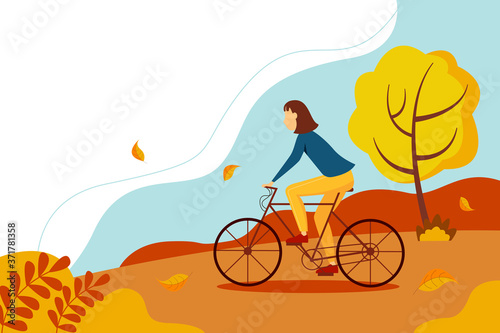 Cyclist-an athlete on a Bicycle. Girl in a sweater riding a bicycle in the park. Cute autumn landscape with trees and leaves.