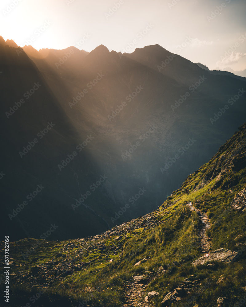 colorful sunset on top of austrian mountain alps