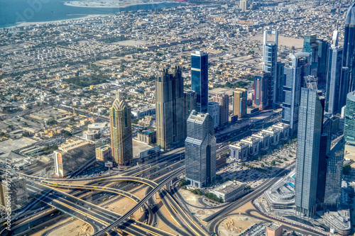 Dubai, United Arab Emirates - September 2, 2016. Urbanistic view of Dubai territories from the top of Burj Khalifa skyscraper, tall buildings on the sunny autumn day