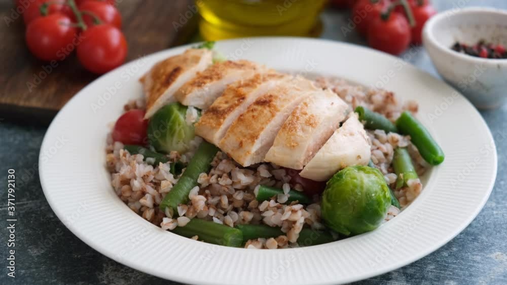 Grilled chicken breast with buckwheat and vegetables. Serving healthy food. Clean eating, diet food concept Grilled chicken breast with buckwheat and vegetables. Serving healthy food. Clean eating, diet food concept