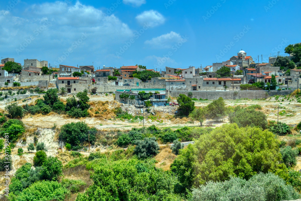 A small mountain village with stone houses in the mountain region of Troodos, Cyprus.  A small Cypriot settlement located on cliffs covered with sparse vegetation.