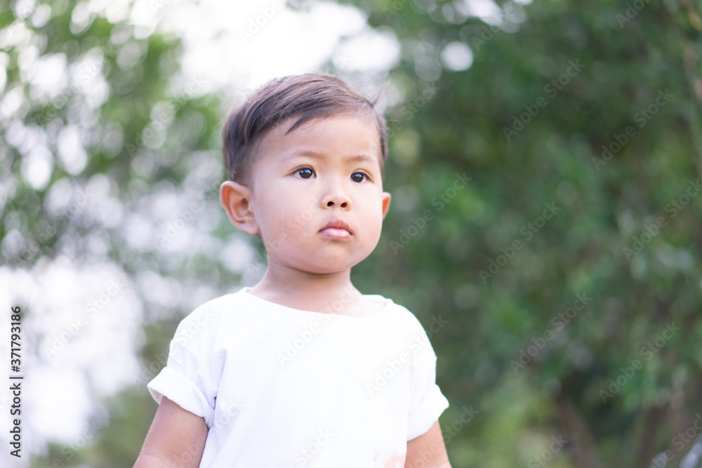 Asian boys wear white shirts in a green background. Asian boys wear white shirts in a green background.