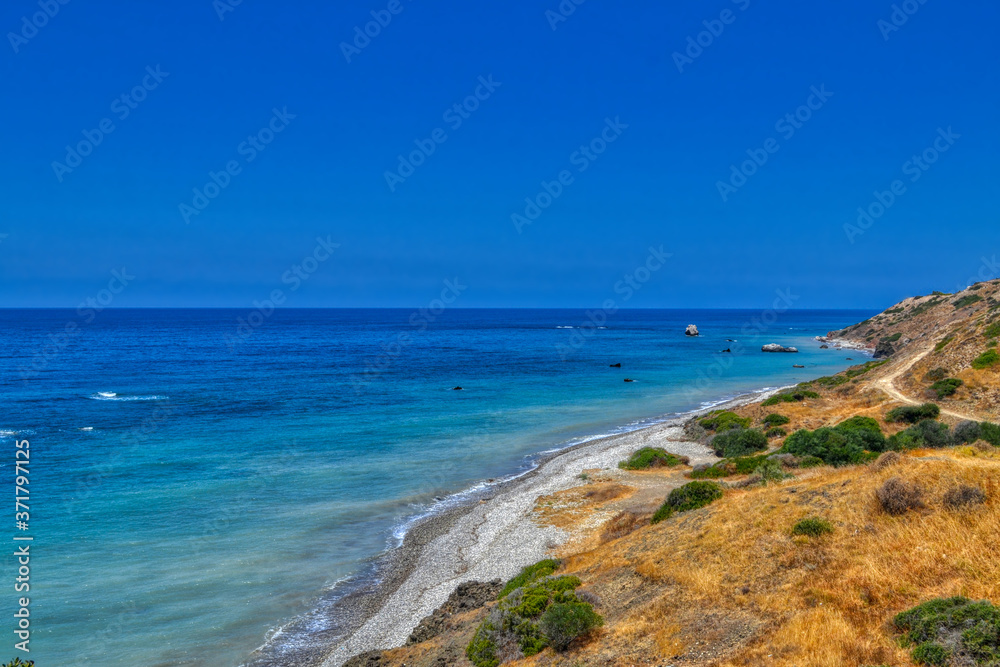View of the Aphrodite's beach from the mountain observation platform on a sunny hot day.  The famous beach on the island of Cyprus, near the town of Paphos.
