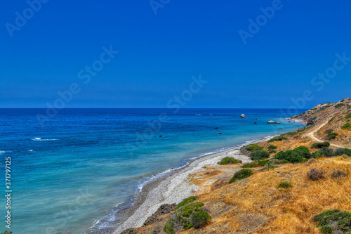 View of the Aphrodite's beach from the mountain observation platform on a sunny hot day. The famous beach on the island of Cyprus, near the town of Paphos.