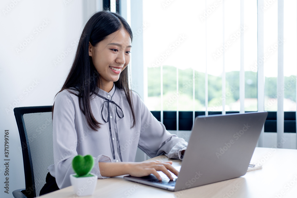 Young women are happy to shop online to make payments over the Internet in the laptop, Internet travel and world of communication and internet commerce concept. Young women are happy to shop online to make payments over the Internet in the laptop, Internet travel and world of communication and internet commerce concept.