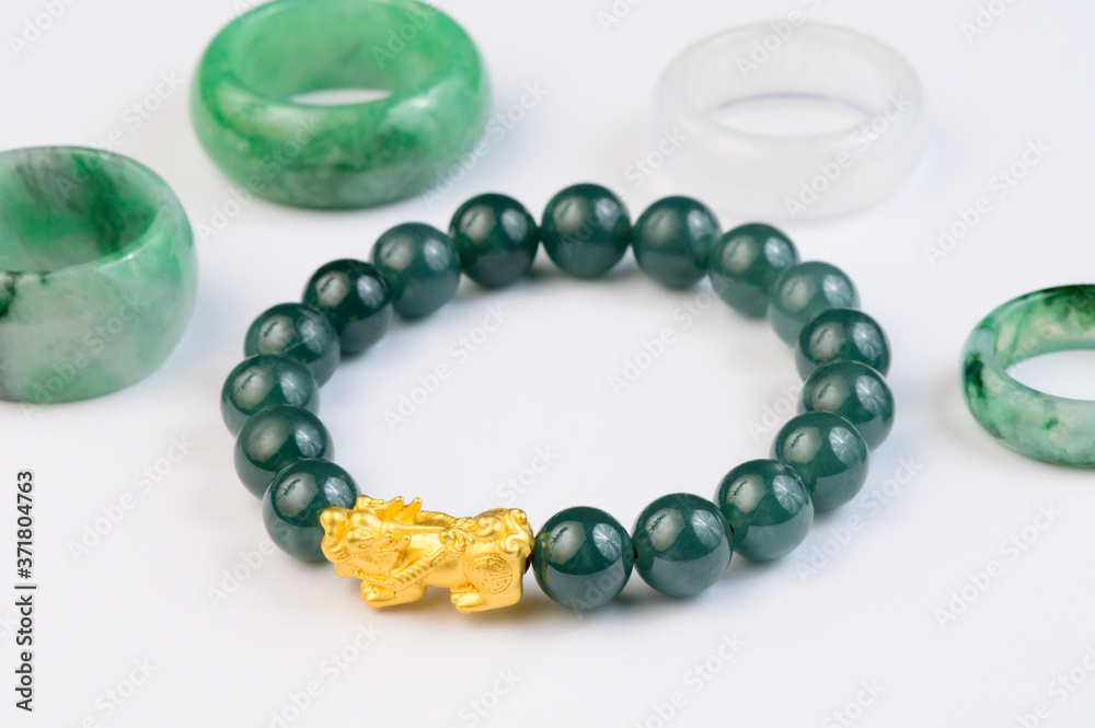 Green bracelet jade with jadeite ring on background Green bracelet jade with jadeite ring on background