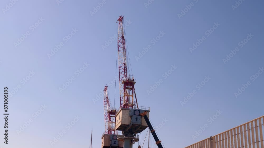 Two Huge Cranes Used in Shipyards for Construction and Maintenance work - slow motion Two Huge Cranes Used in Shipyards for Construction and Maintenance work - slow motion