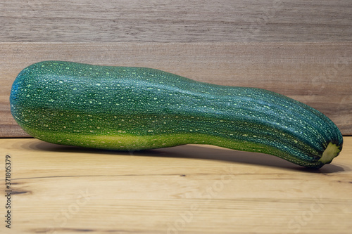 green zucchini with wooden background