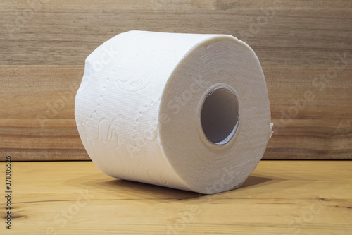 white toilet paper roll with wooden background