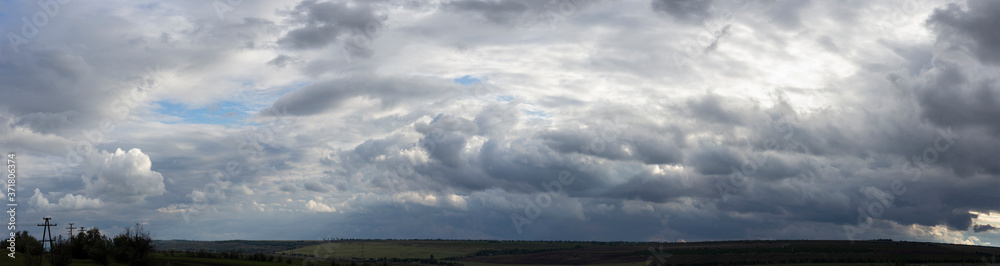 Storm clouds cover the landscape. Tragic gloomy sky. Panorama. Village in the steppe. Fantastic skies on the planet earth. Storm clouds cover the landscape. Tragic gloomy sky. Panorama. Village in the steppe. Fantastic skies on the planet earth.