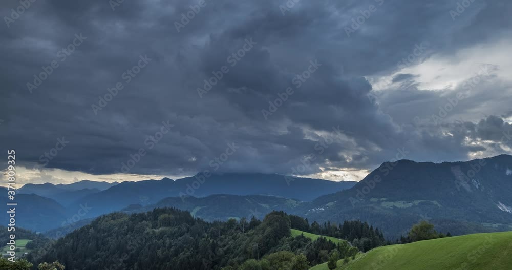 Time lapse storm clouds moving over beautiful countryside covered with trees. Hills and mountains in Slovenia. Dramatic clouds in the sky. Wide, zoom in, 4K Time lapse storm clouds moving over beautiful countryside covered with trees. Hills and mountains in Slovenia. Dramatic clouds in the sky. Wide, zoom in, 4K