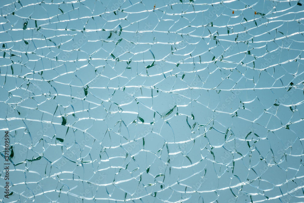 Fototapeta premium Cracks in the glass. Broken glass, texture background design object