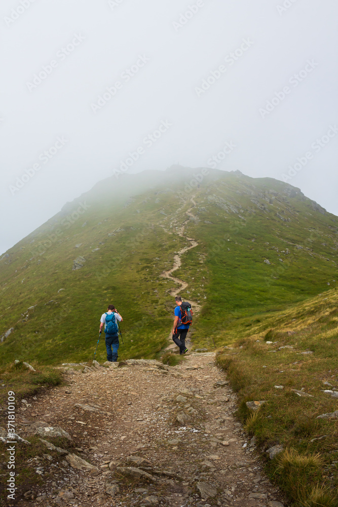 Climbers on a Scottish Munro Mountain in the mist 
