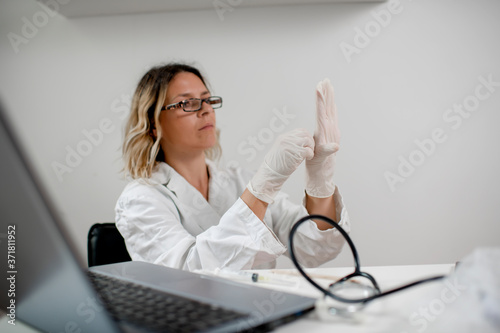 Young female doctor preparing syringe with the new vaccine in a medical clinic