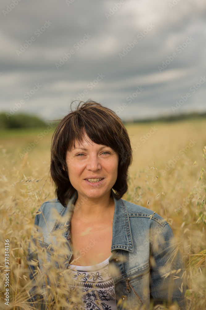 Portrait of a young woman enjoy the autumn sun on a yellow field Portrait of a young woman enjoy the autumn sun on a yellow field