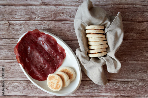tigelle, typical Italian regional dish, served with bresaola