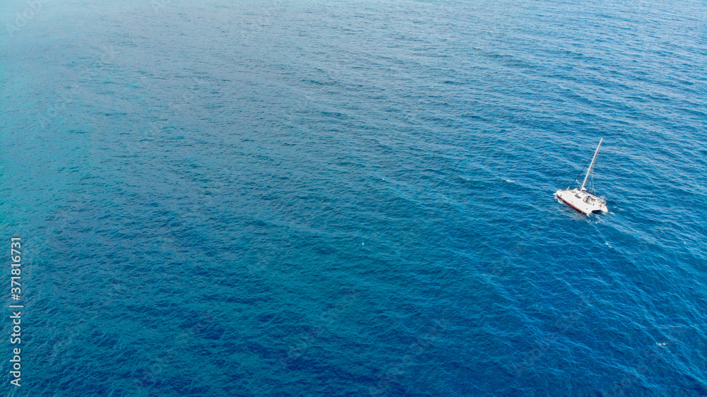 Catamaran sailing in the open sea. top view of a quadcopter Catamaran sailing in the open sea. top view of a quadcopter