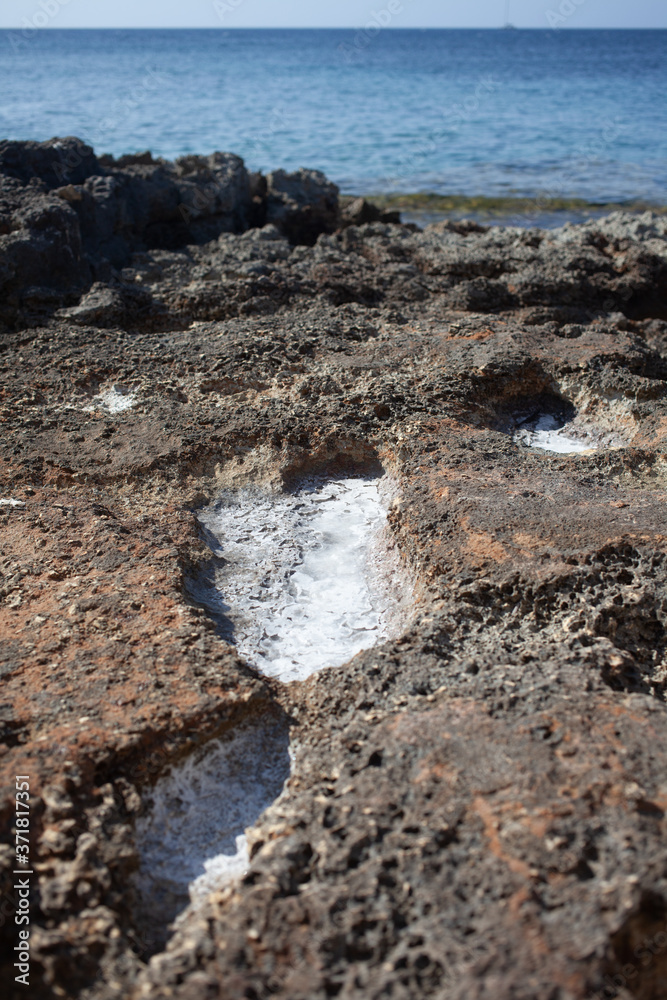 Obraz premium The puddles on the shore dry up, leaving only sea salt.