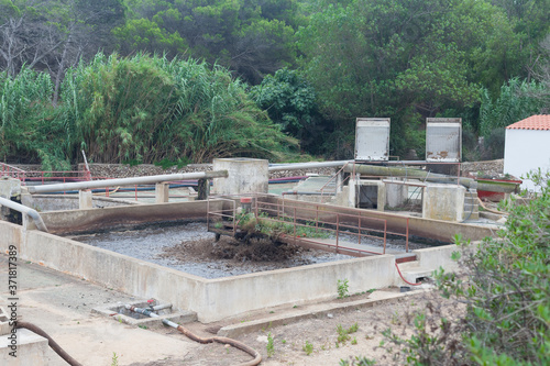 Wastewater treatment plants, lush vegetation around